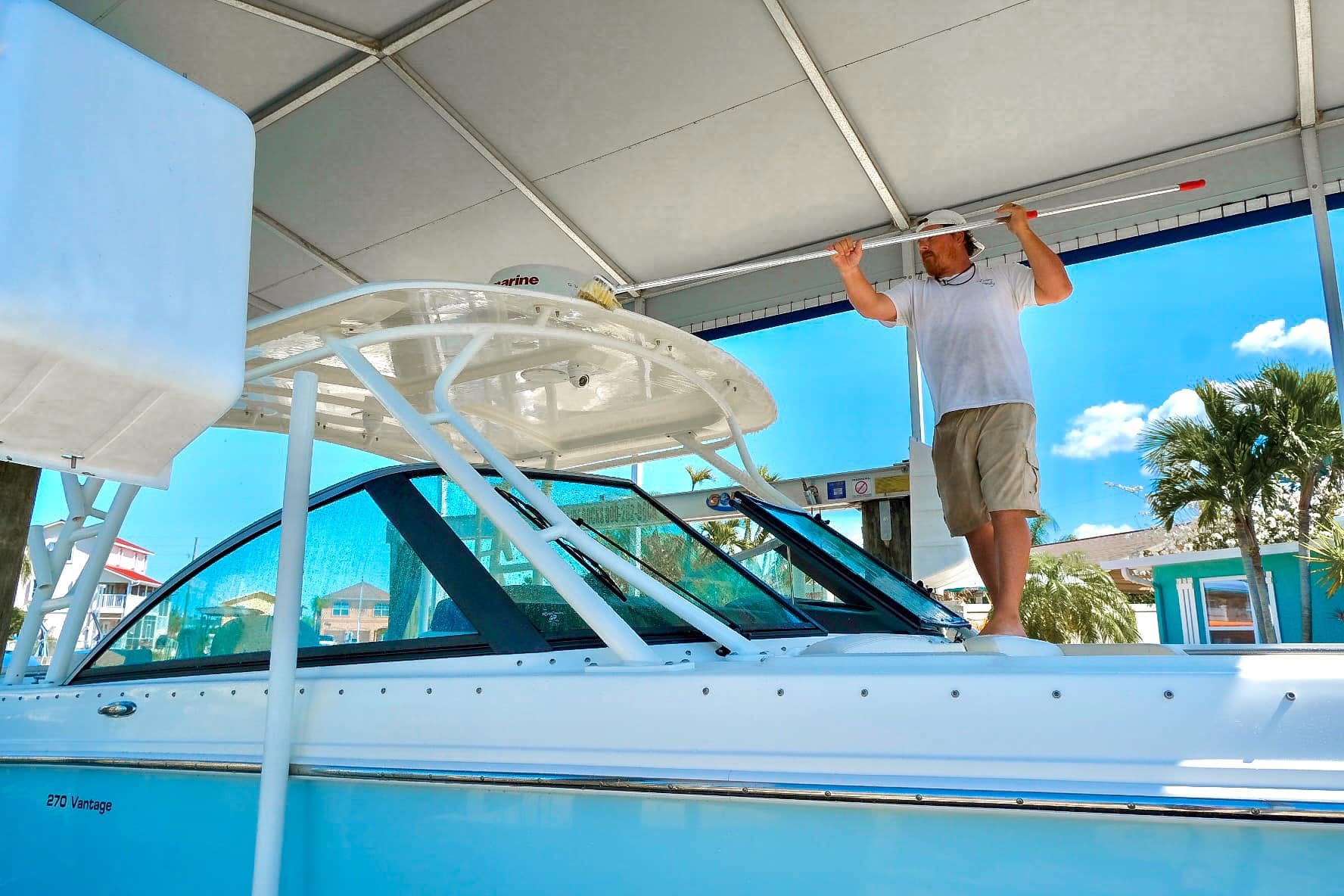 Technician detailing the hardtop of a vessel