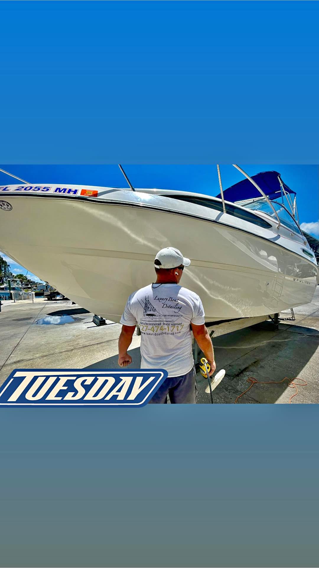 Luxury Boat Detailing technician with a freshly finished, polished boat